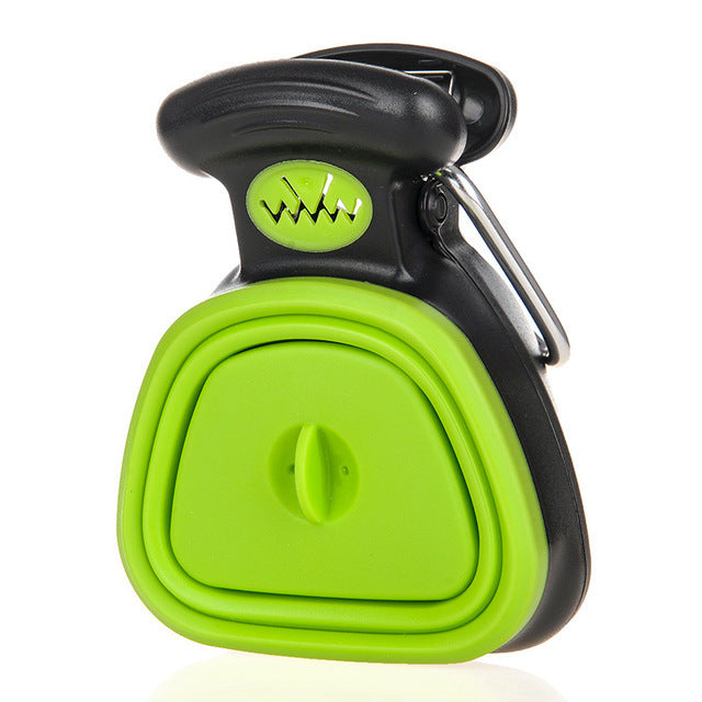Green foldable dog pooper scooper closed, with carabiner clip on the handle