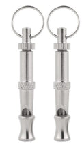Close-up of two silver ultrasonic dog whistles with keyrings and adjustable frequency barrels
