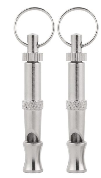 Close-up of two silver ultrasonic dog whistles with keyrings and adjustable frequency barrels