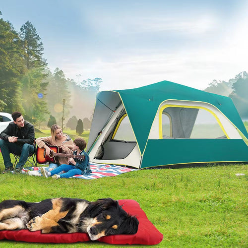 Camping scene with a family by a tent in the woods while a dog rests on the red roll-up travel bed on the grass in the foreground.