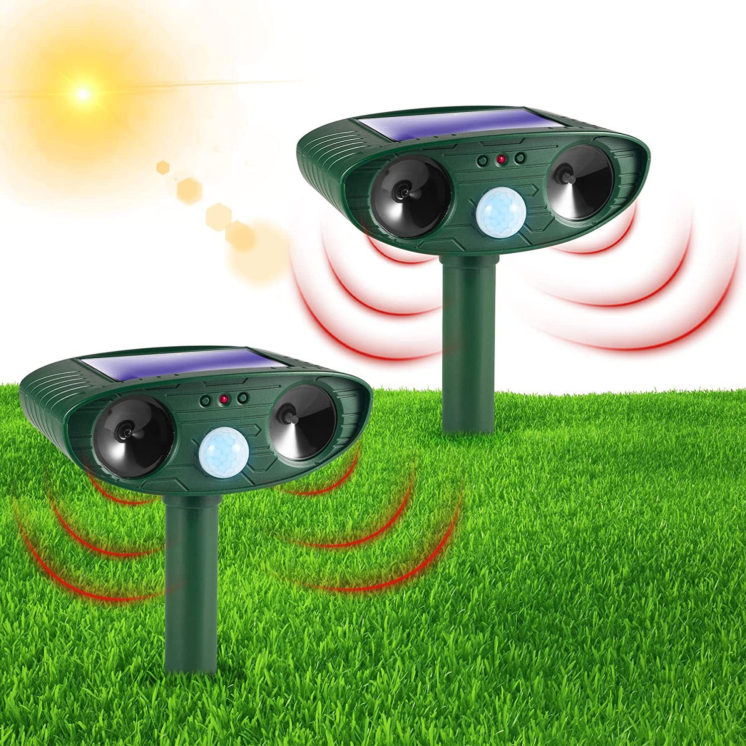 Pair of green solar ultrasonic repellents planted in a bright grassy lawn under the sun, broadcasting red ultrasonic waves across the yard.