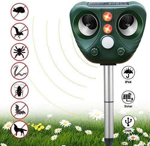 Green solar repellent on a metal stake in a flowery meadow directing waves at crossed-out icons of pests like mice, birds, spiders, and dogs, with IP44, solar, and USB badges.