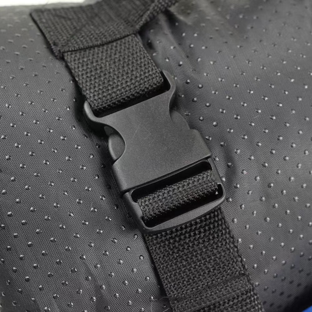 Close-up of the black quick-release buckle and webbing carry strap on the dog bed's textured waterproof fabric.