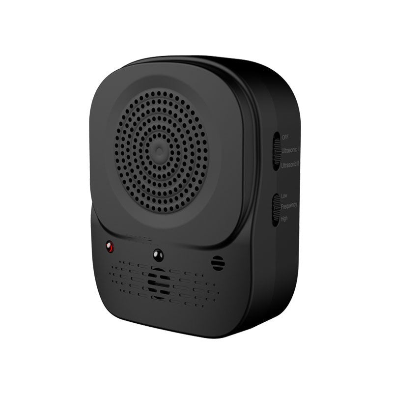 Three-quarter view of the black ultrasonic anti-barking device on a white background, with its perforated speaker face and side switches for ultrasonic mode and frequency level.